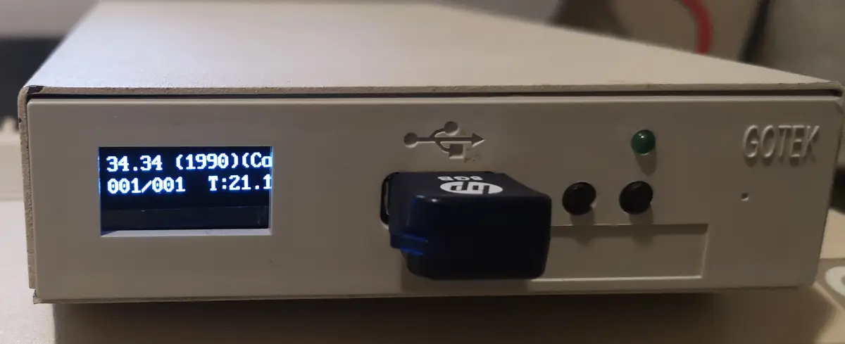 Gotek Floppy Emulator with oled screen in external 3.5" floppy casing showing FlashFloppy loading an Am iga Workbench disk from USB stick
